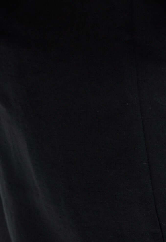 Close-up of a solid black linen fabric, showcasing texture and breathability of the women's bermuda linen shorts Brooklyn.