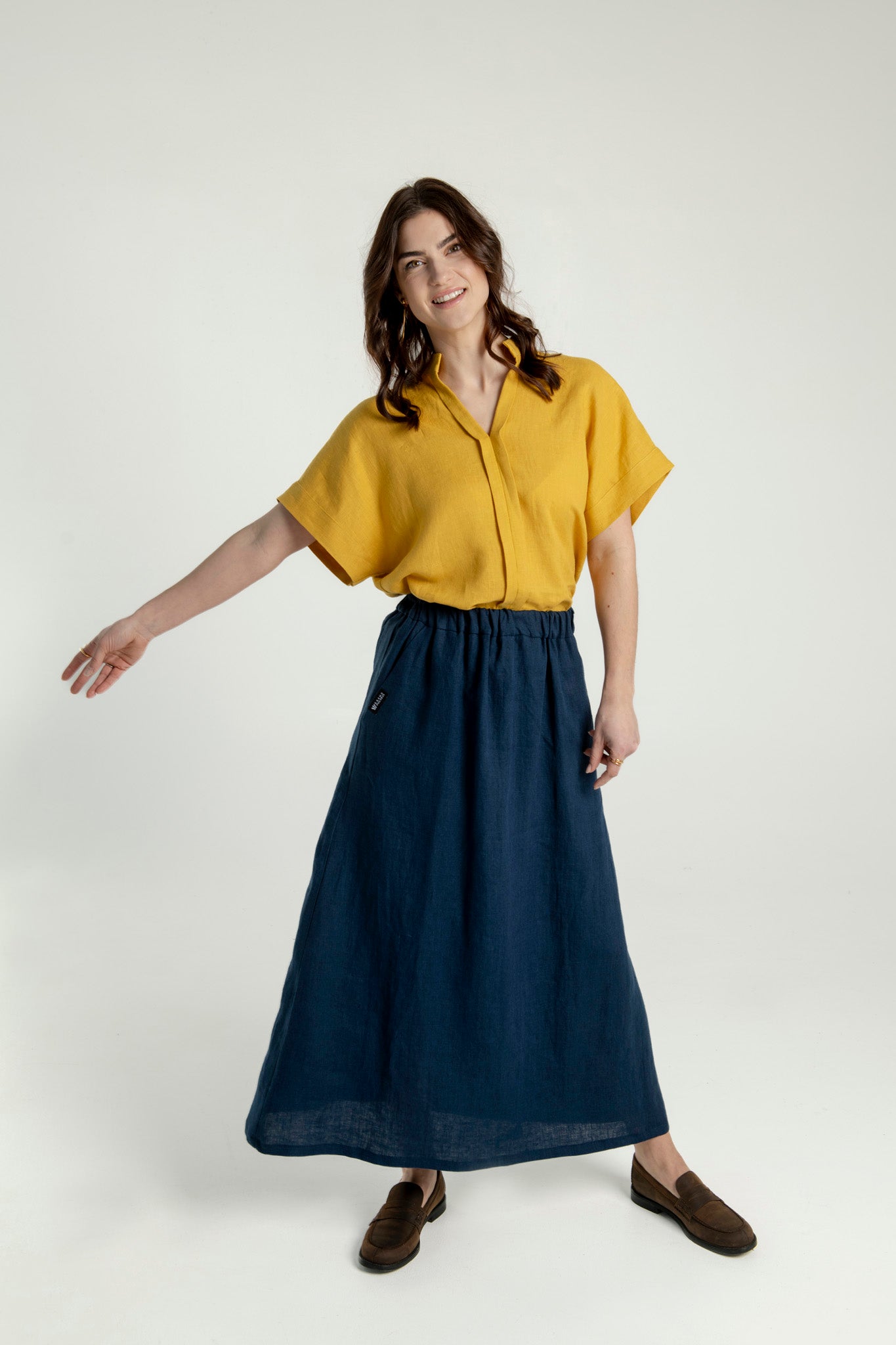 Model wearing a Japanese style linen top in yellow and a long navy skirt, showcasing a relaxed silhouette.