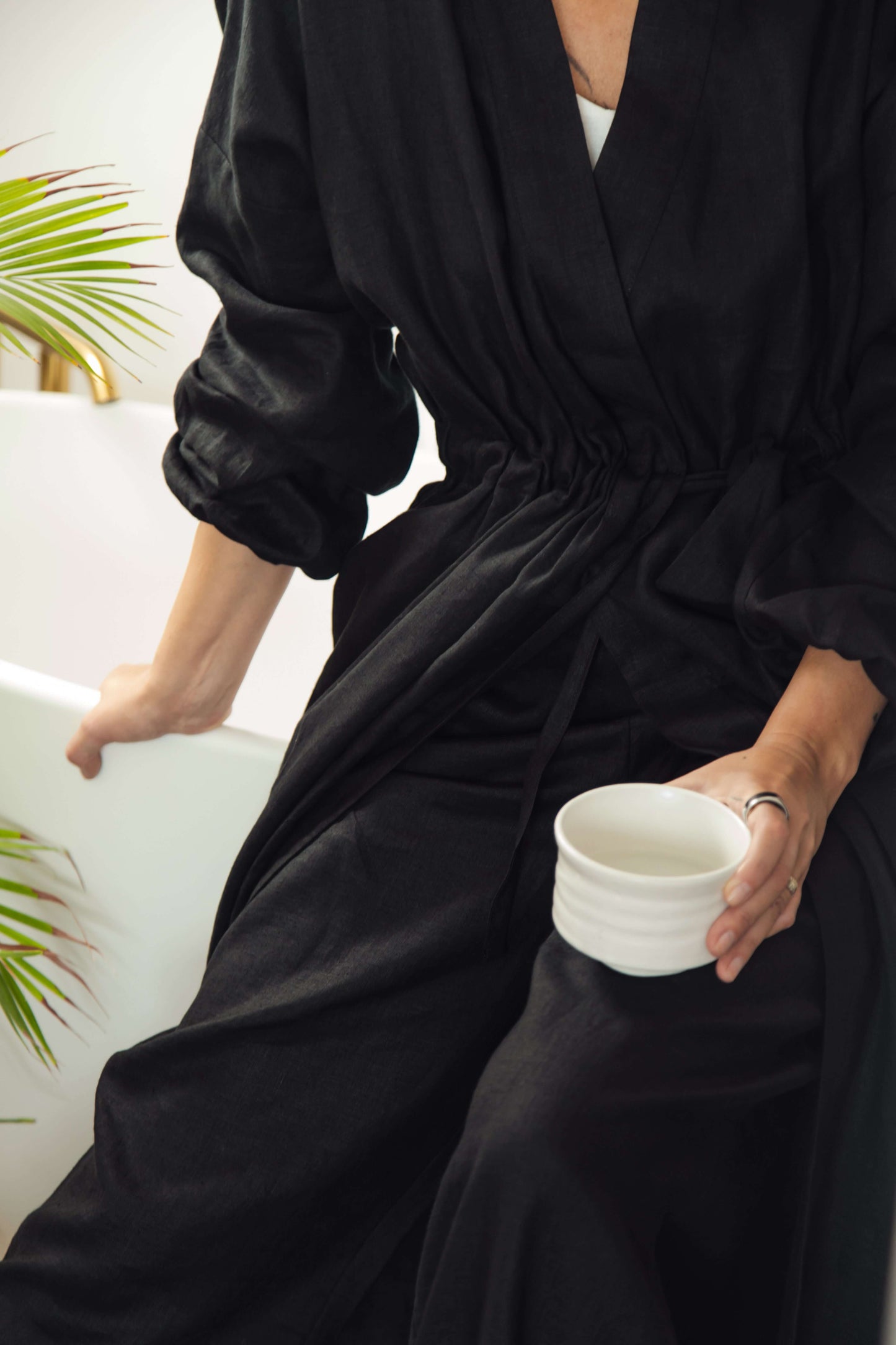 Women's short linen robe in black.