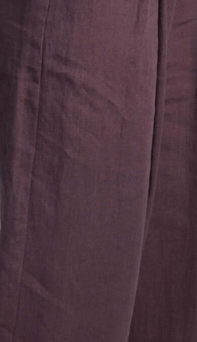 Close-up of a plum linen fabric, showcasing texture and breathability of women's linen waistcoat Vesta.