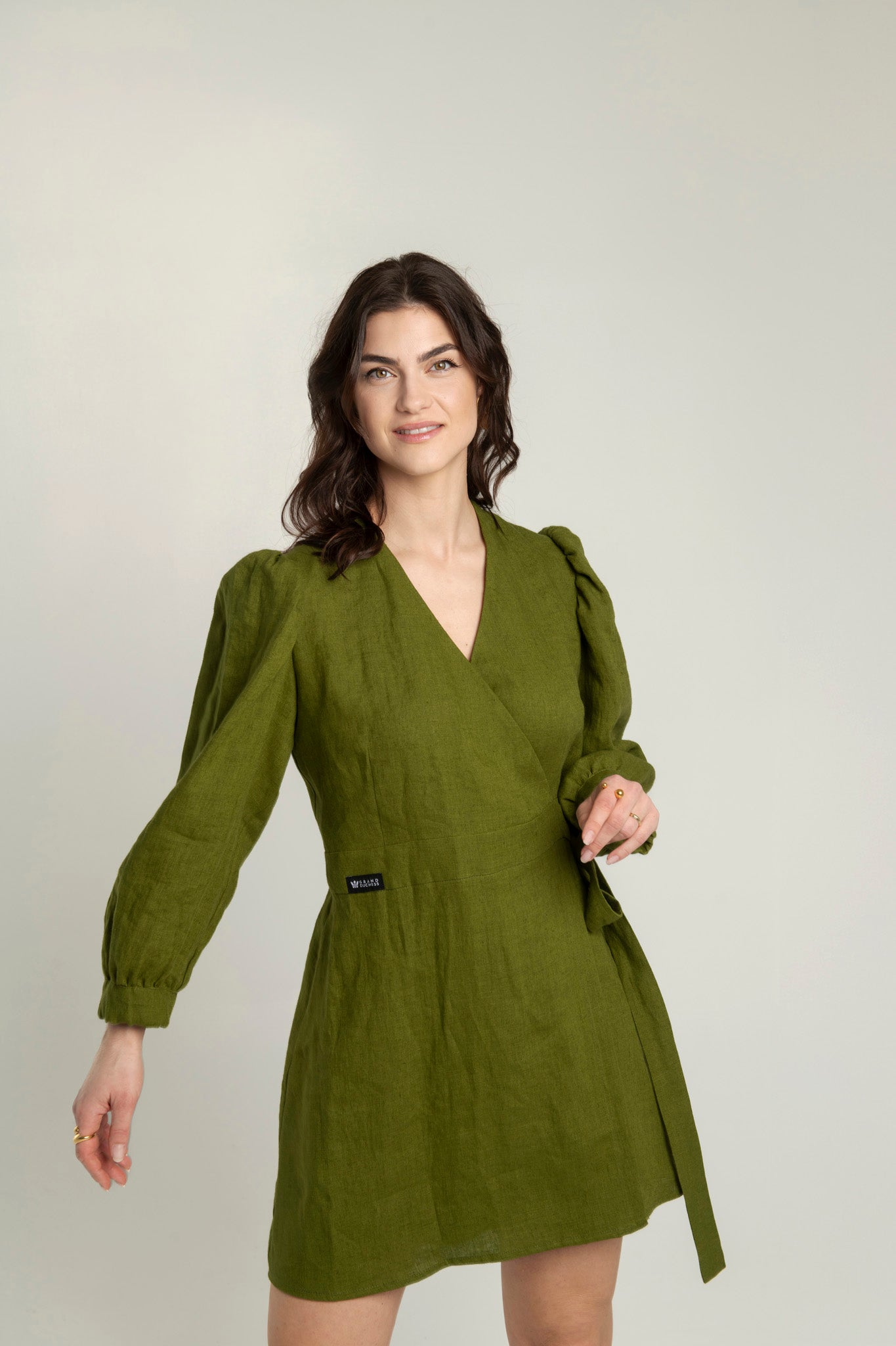 Green linen crossover linen mini dress with pockets Madelaine with long sleeves and a V-neck.
