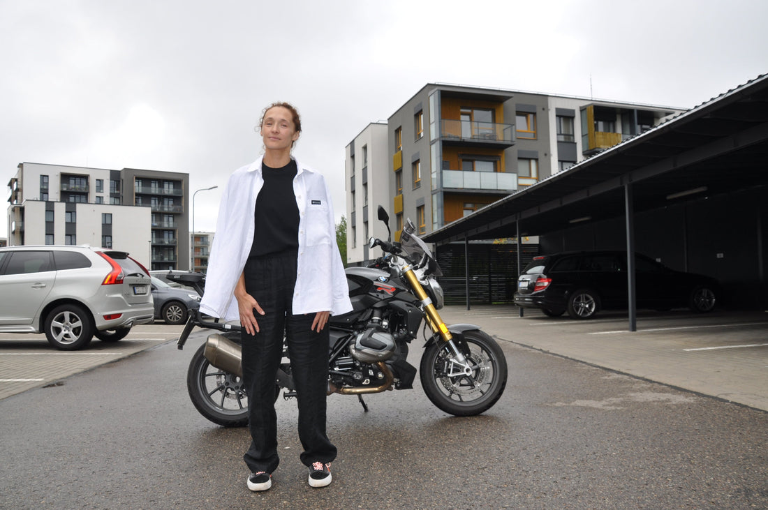Ilona wearing Grand Duchess women’s oversized linen shirt Liberty, embodying yoga therapy and femininity while riding a bike