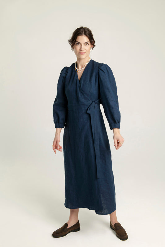 Crossover linen midi dress with pockets, fit-and-flare design.