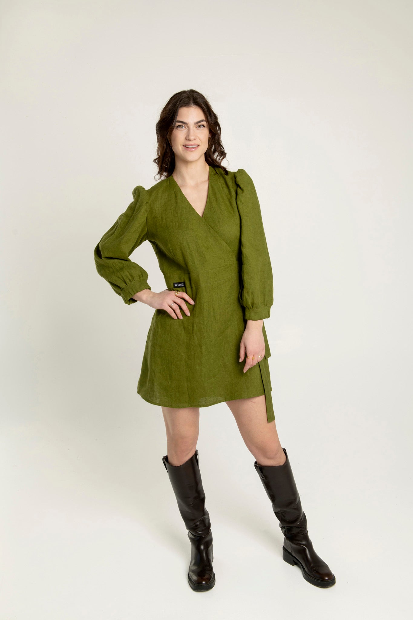 Madeleine crossover linen mini dress with pockets in olive green with adjustable waist.