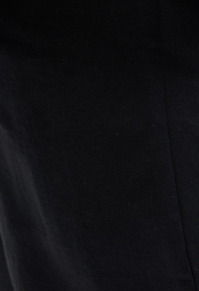 Close-up of soft black color 100% natural softened linen fabric texture on the Madeleine crossover linen mini dress with pockets.