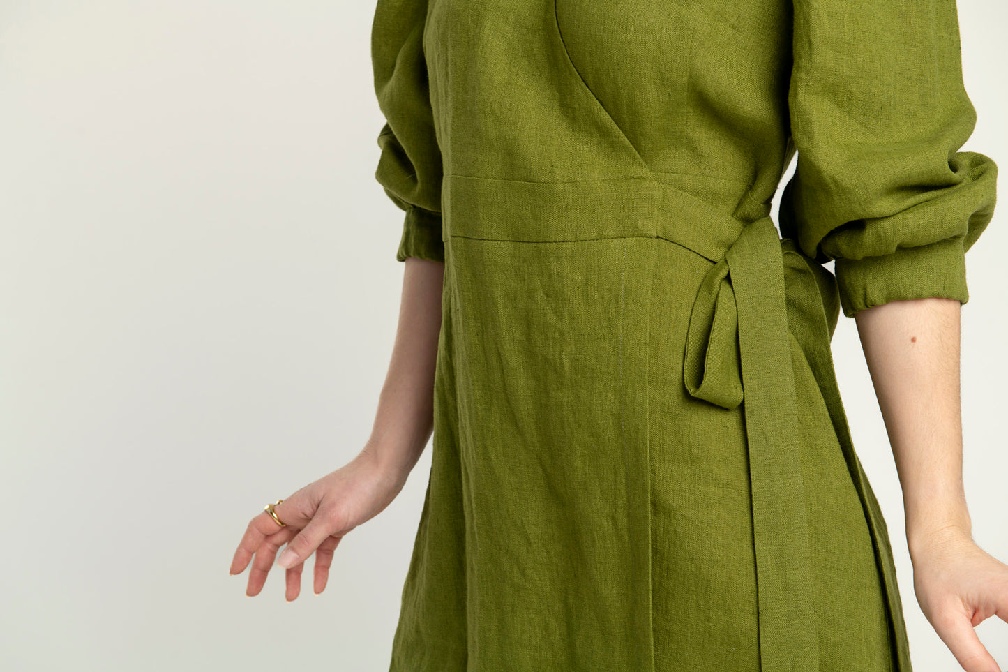 Olive green Madeleine crossover linen mini dress with pockets, puffed long sleeves and V-neckline, stylish and breathable.