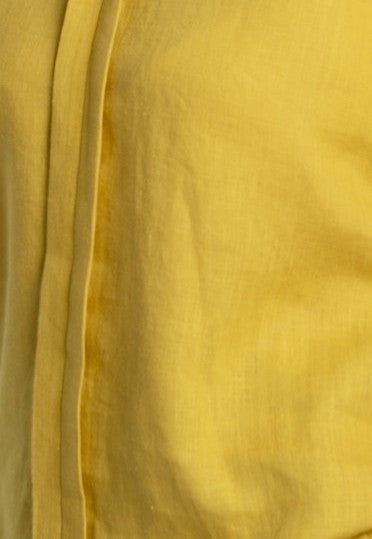 Close-up of mustard yellow color natural linen fabric, highlighting the texture and breathable quality of the women’s Soho linen maxi skirt with pockets.
