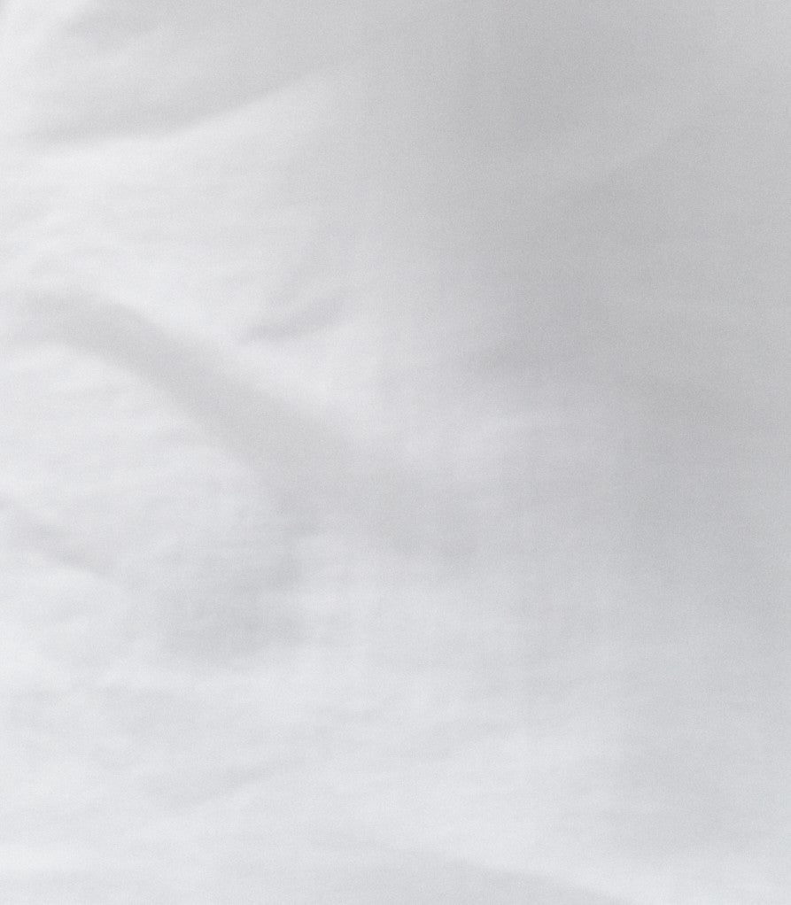 Close-up of white color natural linen fabric, highlighting the texture and breathable quality of the women’s Soho linen maxi skirt with pockets.