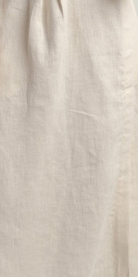 Close-up of beige color natural linen fabric, highlighting the texture and breathable quality of the women’s Soho linen maxi skirt with pockets.
