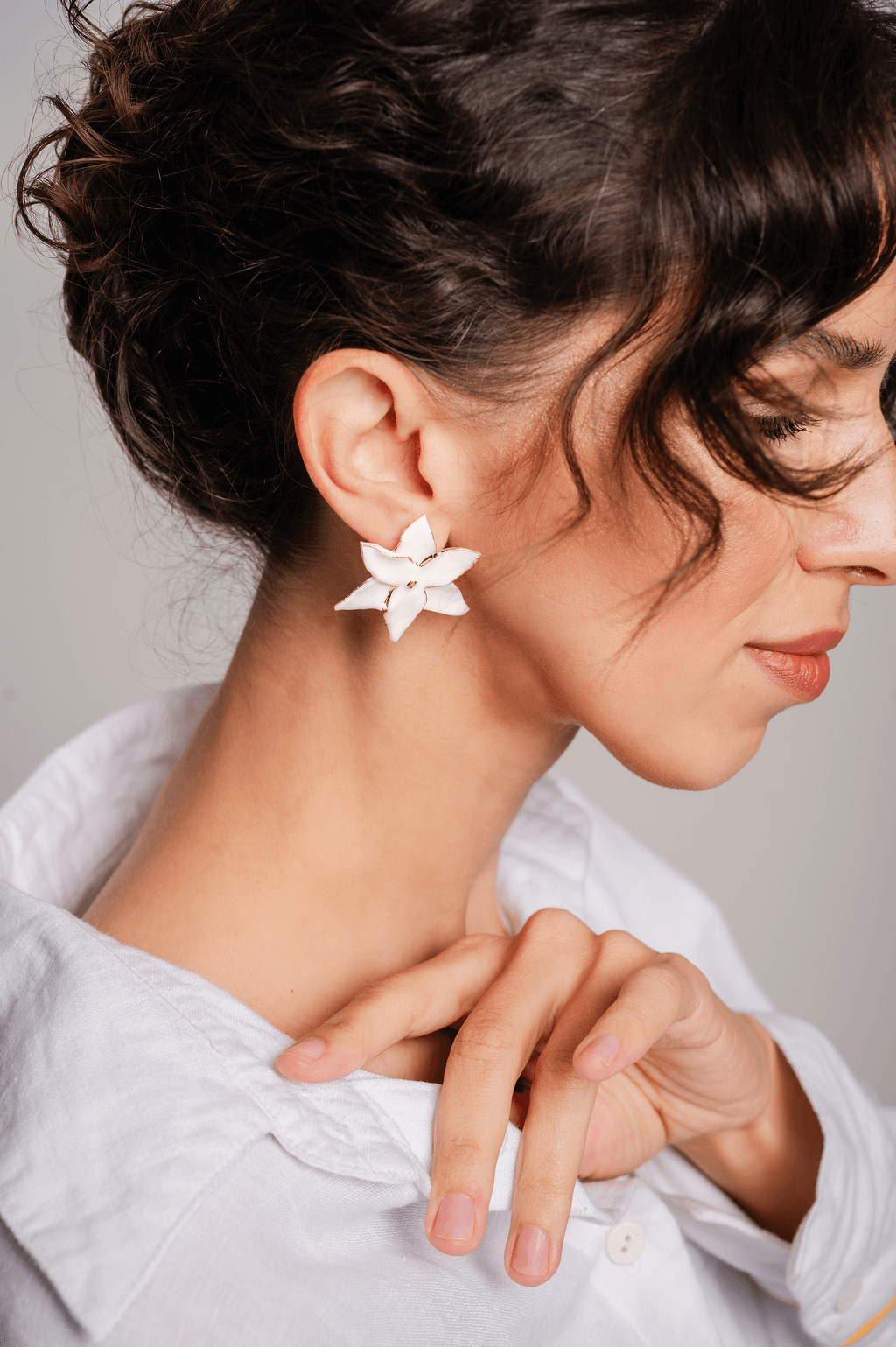Unique handmade flower-shaped porcelain earrings with 12K gold detailing, hypoallergenic and lightweight, elegant statement jewelry.