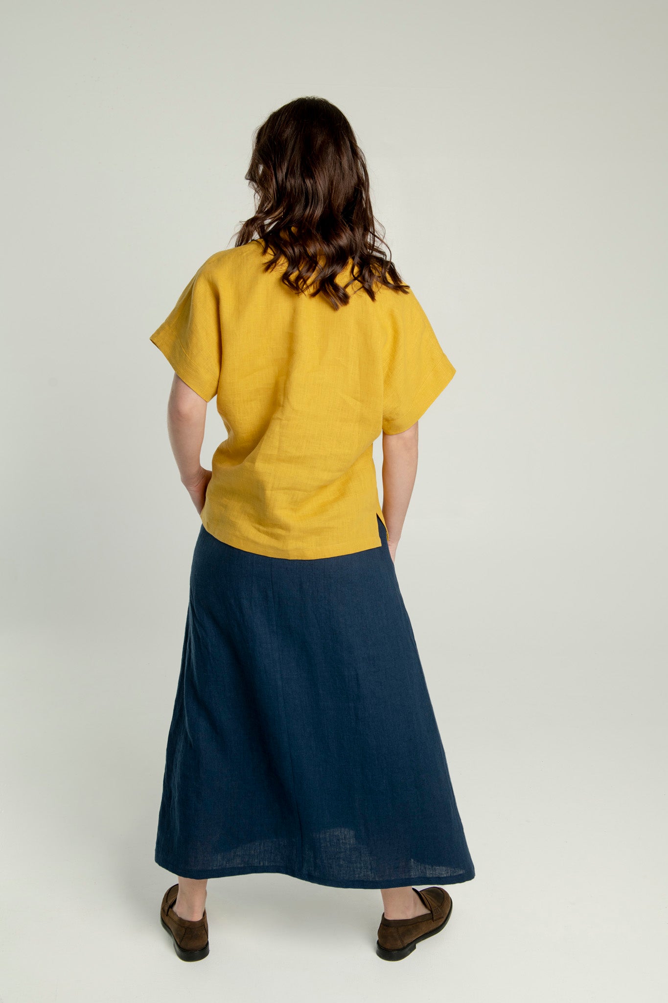 Back view of linen maxi skirt with pockets and elastic waist.